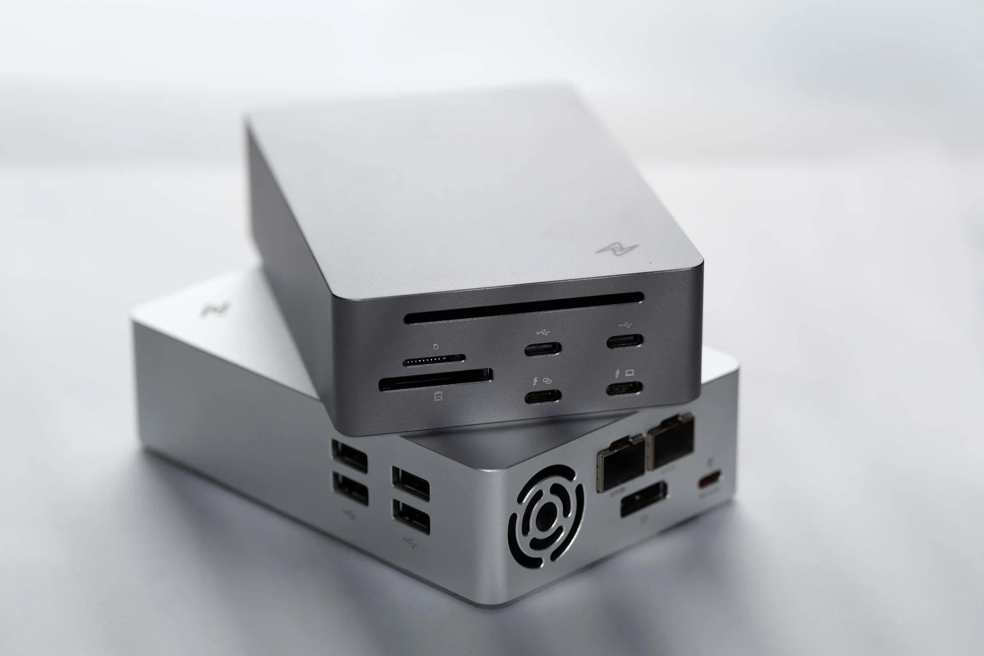LightOne gray and silver 25GbE Thunderbolt docking stations showing front and rear I/O