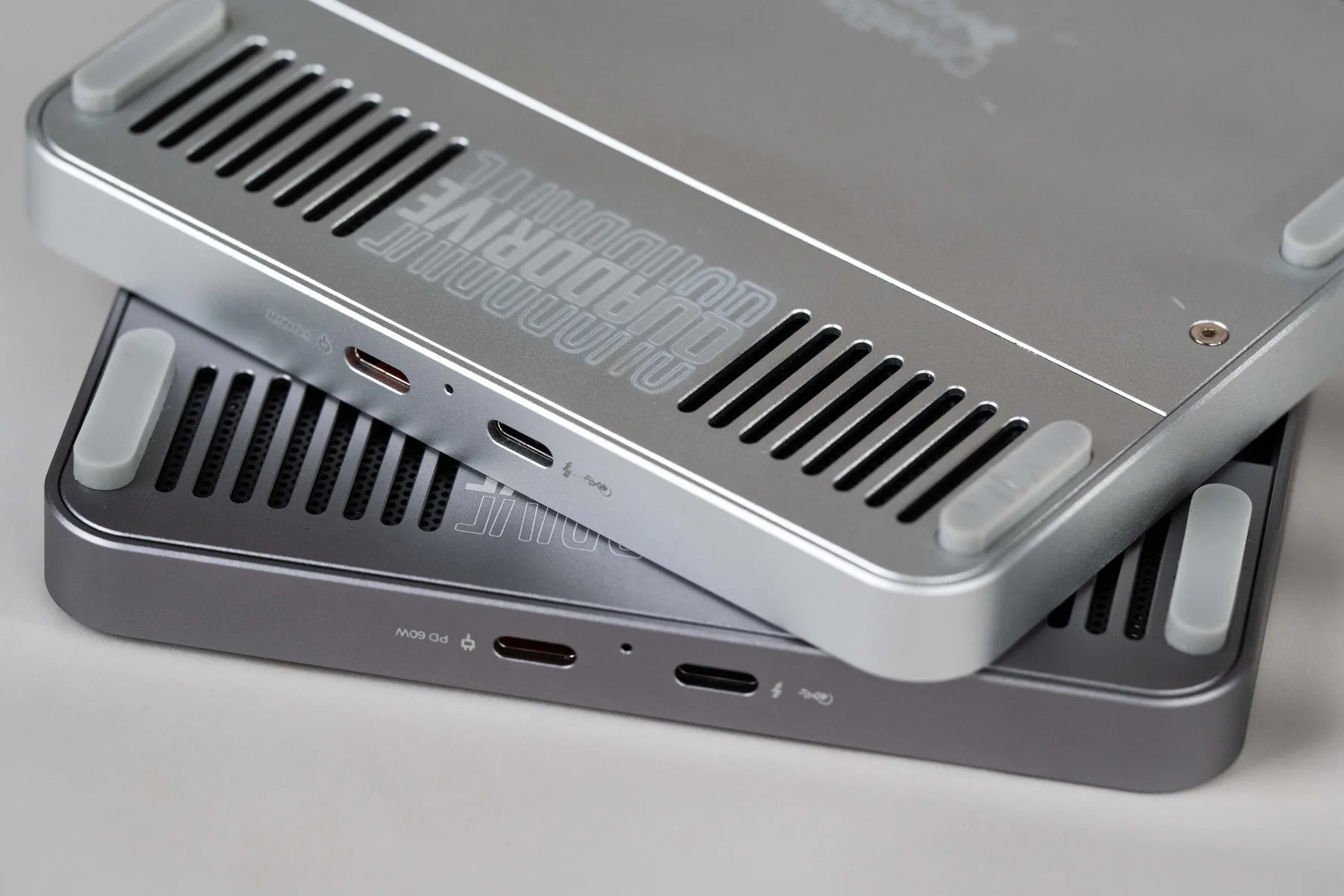 Two QuadDrive enclosures stacked to show vents, ports, and machined finish