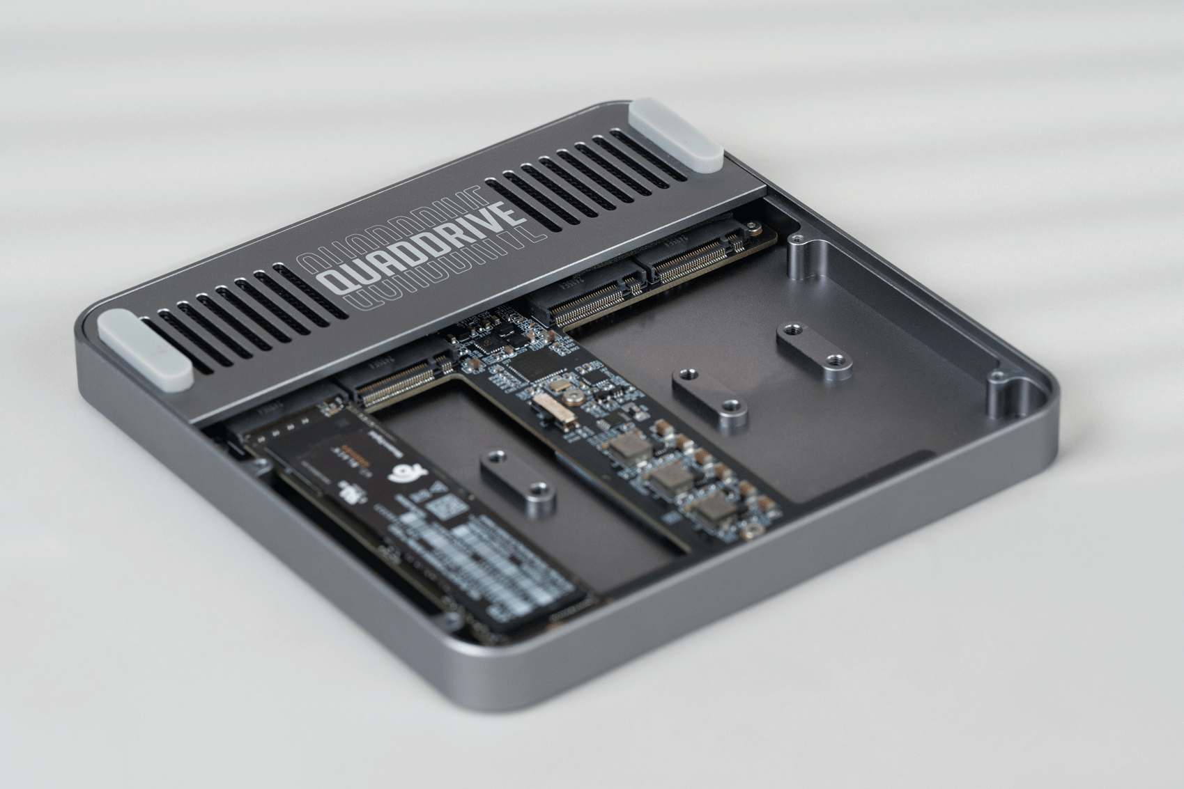 QuadDrive bay sequence showing M.2 NVMe SSDs appearing one by one